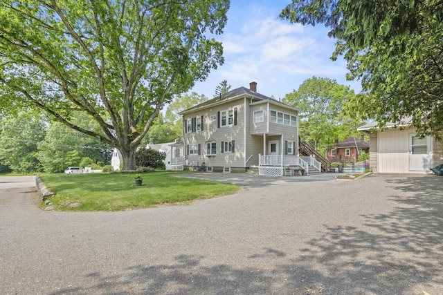 20 Houghton St, Webster, MA 01570 - view of front facade with a chimney and a front lawn