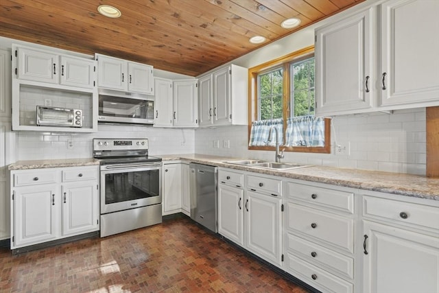 20 Houghton St, Webster, MA 01570 - kitchen with appliances with stainless steel finishes, wood ceiling, brick patterned floors, white cabinets, and recessed lighting