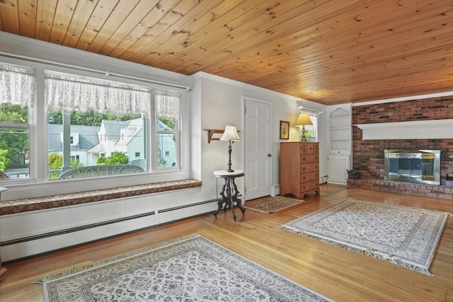 20 Houghton St, Webster, MA 01570 - living room with a baseboard radiator, ornamental molding, wood finished floors, wood ceiling, and a brick fireplace