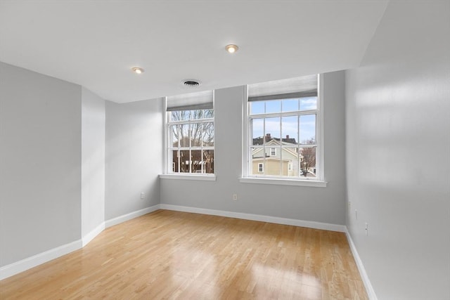 unfurnished room with light hardwood / wood-style flooring