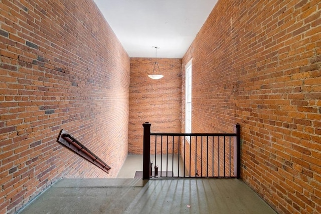 hall with brick wall and a towering ceiling