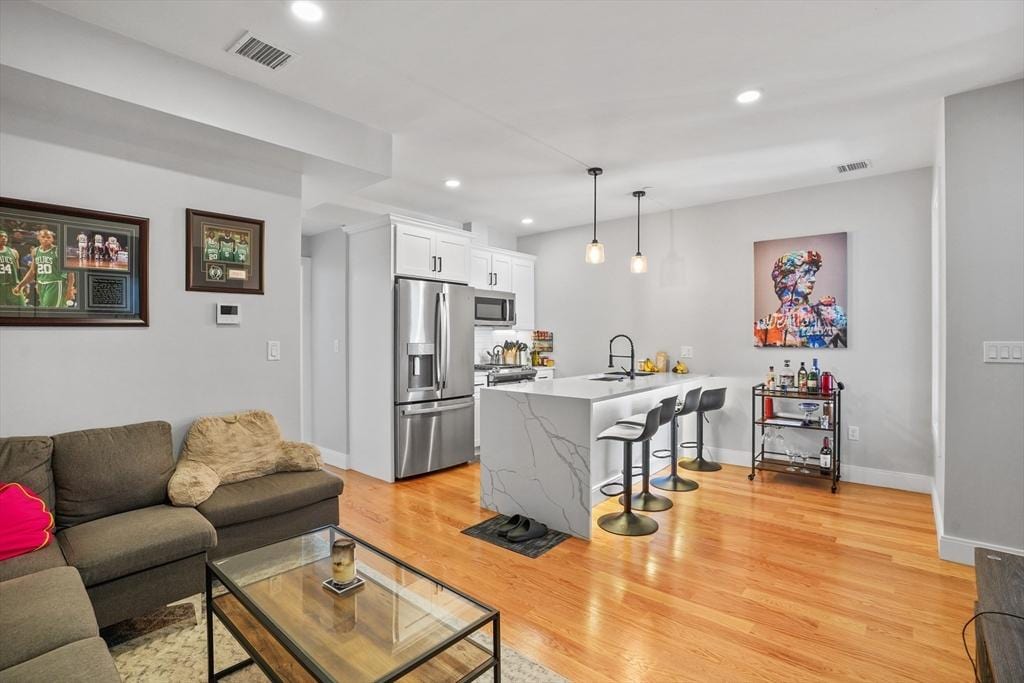 174 W 7th St Unit 1, Boston, MA 02127 - living room with visible vents, recessed lighting, light wood-style floors, and baseboards