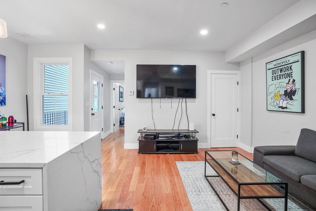 174 W 7th St Unit 1, Boston, MA 02127 - living area featuring light wood-style floors, baseboards, and recessed lighting