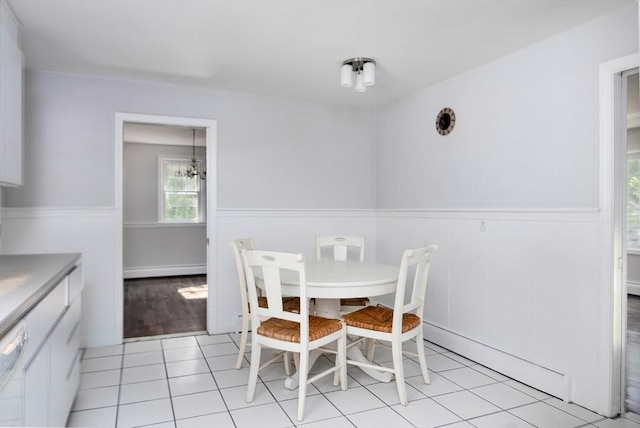 38 Juniper Ln, Holden, MA 01520 - dining room with wainscoting, a chandelier, a baseboard heating unit, and light tile patterned floors