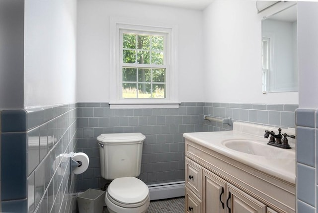 38 Juniper Ln, Holden, MA 01520 - bathroom featuring tile walls, a wainscoted wall, vanity, toilet, and a baseboard heating unit