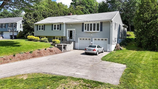 38 Juniper Ln, Holden, MA 01520 - raised ranch with driveway, an attached garage, a front yard, and a chimney