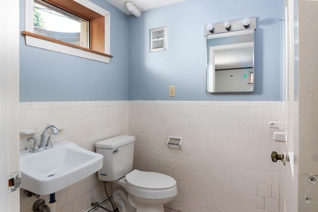 38 Juniper Ln, Holden, MA 01520 - bathroom with tile walls, toilet, a sink, and a wainscoted wall