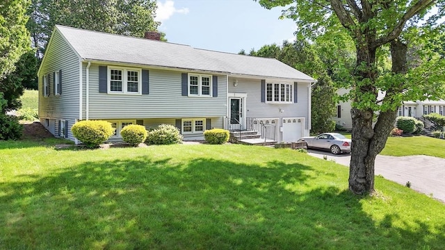 38 Juniper Ln, Holden, MA 01520 - split foyer home with a chimney, a garage, driveway, and a front lawn