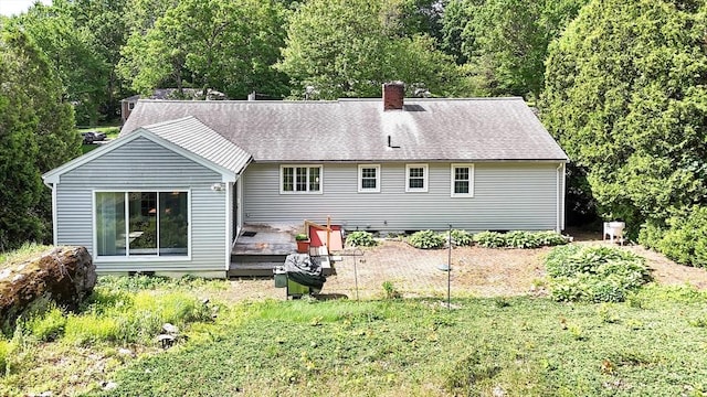 38 Juniper Ln, Holden, MA 01520 - back of property featuring a chimney, a deck, and a forest view
