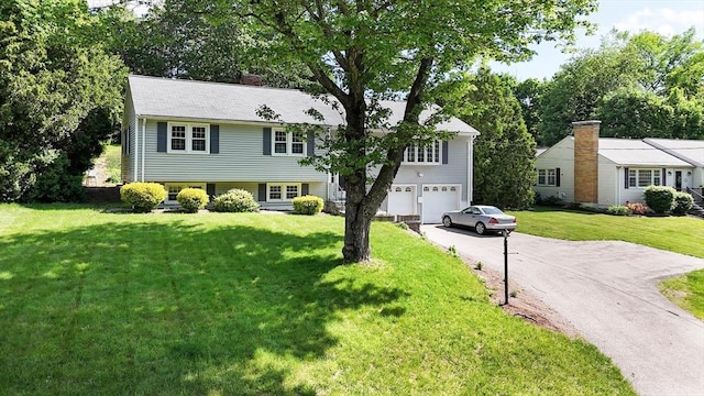 38 Juniper Ln, Holden, MA 01520 - view of front facade featuring asphalt driveway, a garage, a front yard, and a chimney