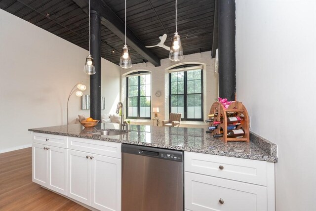 kitchen featuring wooden ceiling, dishwasher, beam ceiling, dark stone counters, and sink