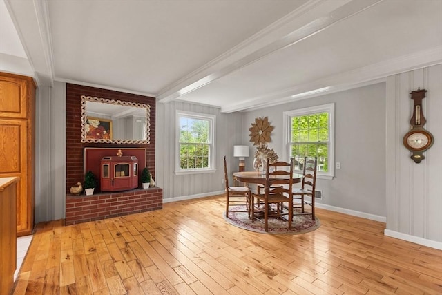 124 Hillside Rd, North Andover, MA 01845 - dining room with light wood finished floors, healthy amount of natural light, ornamental molding, beam ceiling, and a wood stove
