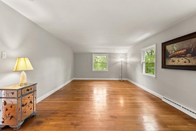 124 Hillside Rd, North Andover, MA 01845 - empty room with a baseboard radiator and wood finished floors