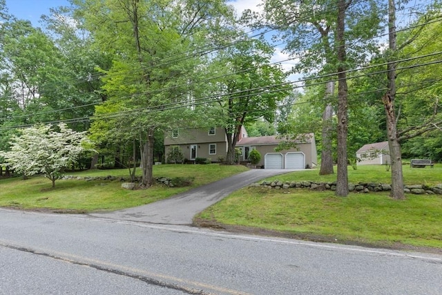 124 Hillside Rd, North Andover, MA 01845 - view of front facade featuring driveway, a front yard, and an attached garage