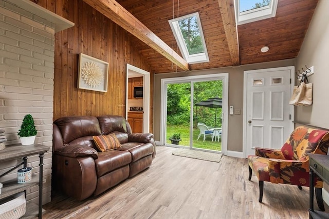 124 Hillside Rd, North Andover, MA 01845 - living area featuring a skylight, light wood-type flooring, wood walls, beam ceiling, and high vaulted ceiling