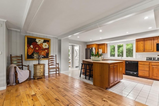 124 Hillside Rd, North Andover, MA 01845 - kitchen with black dishwasher, ornamental molding, beamed ceiling, light wood finished floors, and a kitchen island
