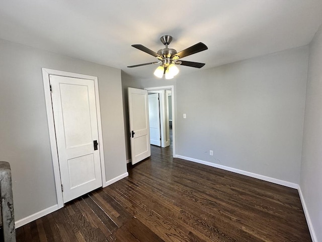unfurnished bedroom featuring baseboards, ceiling fan, and dark wood-style flooring