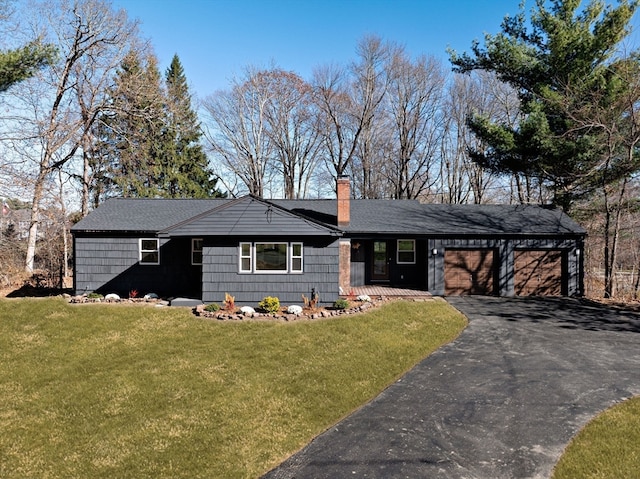 ranch-style house with a front yard and a garage