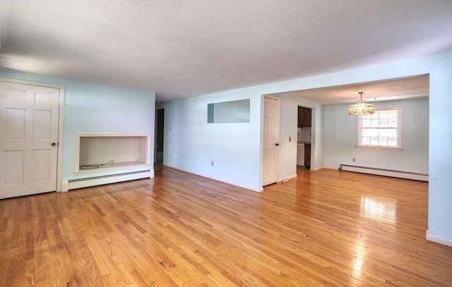 175 Knotty Pine Ln, Barnstable, MA 02632 - unfurnished living room featuring baseboard heating, light wood-type flooring, a chandelier, a textured ceiling, and baseboards