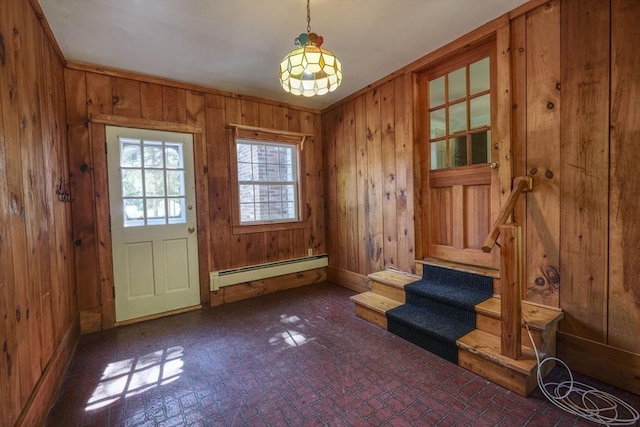 175 Knotty Pine Ln, Barnstable, MA 02632 - entrance foyer featuring baseboard heating, wooden walls, stairway, and brick patterned floors