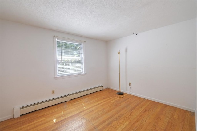 175 Knotty Pine Ln, Barnstable, MA 02632 - unfurnished room featuring baseboard heating, light wood finished floors, a textured ceiling, and baseboards