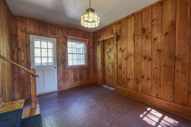 175 Knotty Pine Ln, Barnstable, MA 02632 - foyer entrance with brick patterned floors, wood walls, baseboards, and stairs