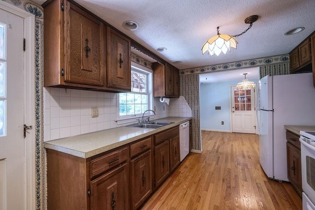 175 Knotty Pine Ln, Barnstable, MA 02632 - kitchen featuring white appliances, a sink, light wood-type flooring, backsplash, and light countertops