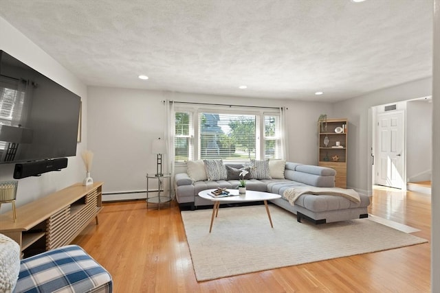 85 Loring Ave, Winchester, MA 01890 - living room featuring a baseboard heating unit, wood finished floors, recessed lighting, and a textured ceiling