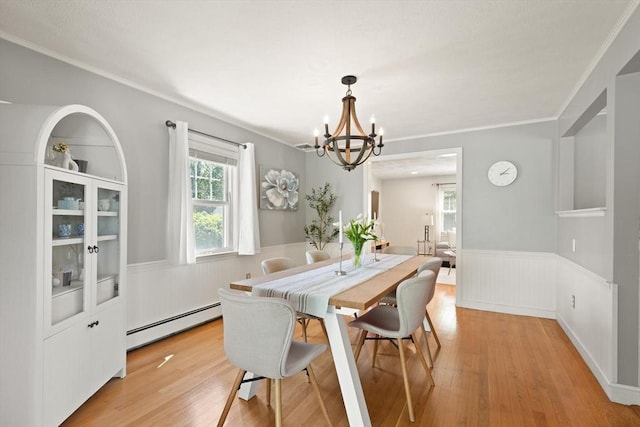 85 Loring Ave, Winchester, MA 01890 - dining area with a baseboard radiator, a wainscoted wall, a chandelier, light wood-type flooring, and ornamental molding