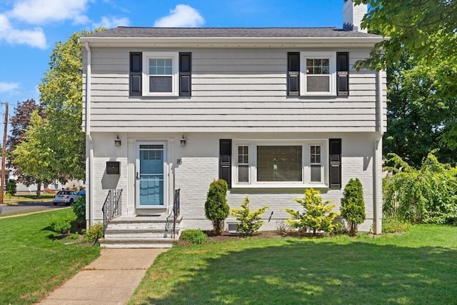 85 Loring Ave, Winchester, MA 01890 - colonial inspired home with brick siding, a chimney, and a front lawn