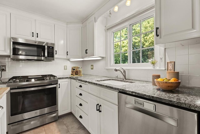85 Loring Ave, Winchester, MA 01890 - kitchen featuring appliances with stainless steel finishes, white cabinets, backsplash, and dark stone countertops