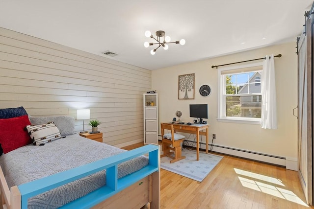 85 Loring Ave, Winchester, MA 01890 - bedroom with a baseboard radiator, light wood-type flooring, an office area, wooden walls, and a chandelier