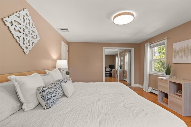 85 Loring Ave, Winchester, MA 01890 - bedroom with baseboard heating and light wood finished floors