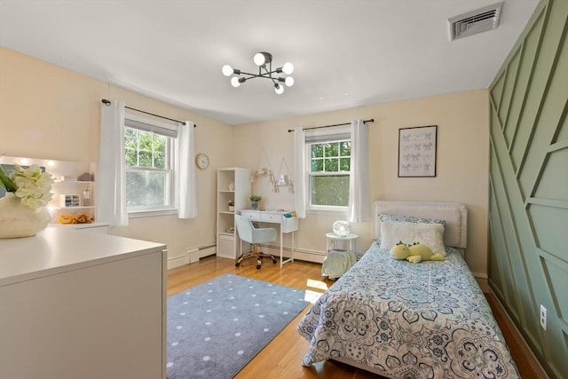 85 Loring Ave, Winchester, MA 01890 - bedroom featuring a baseboard heating unit, wood finished floors, and a chandelier