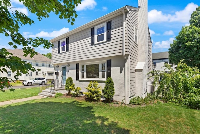 85 Loring Ave, Winchester, MA 01890 - colonial inspired home featuring a chimney, a front yard, and brick siding