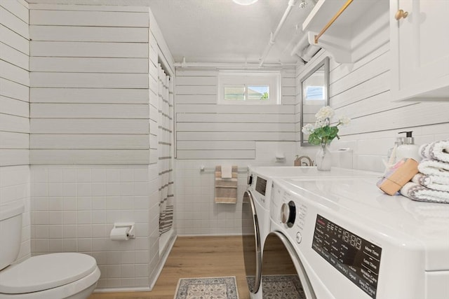 85 Loring Ave, Winchester, MA 01890 - bathroom with separate washer and dryer, wood finished floors, tile walls, and vanity