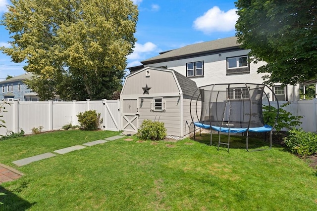 85 Loring Ave, Winchester, MA 01890 - rear view of property featuring a trampoline, a fenced backyard, a gambrel roof, an outdoor structure, and a barn
