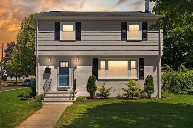 85 Loring Ave, Winchester, MA 01890 - view of front of property with a front yard, a chimney, and brick siding
