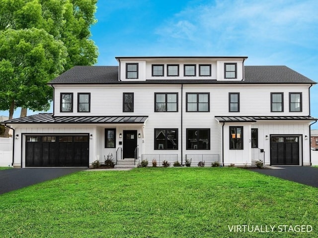 modern farmhouse style home with a front yard and a garage