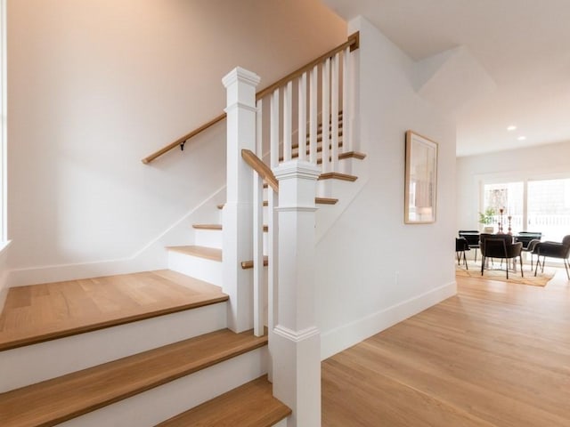 staircase with wood-type flooring