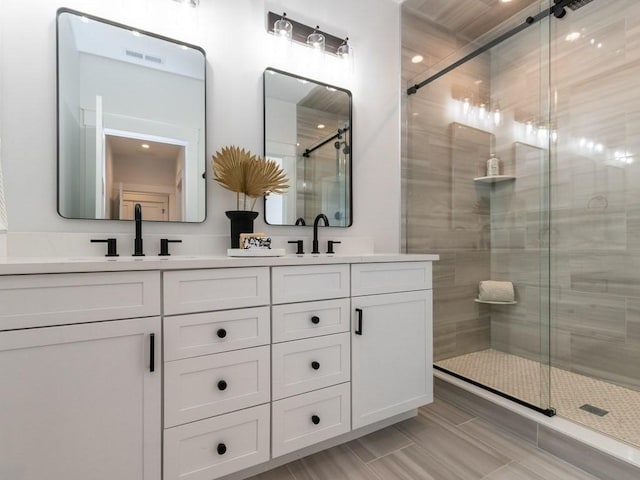 bathroom with vanity and an enclosed shower