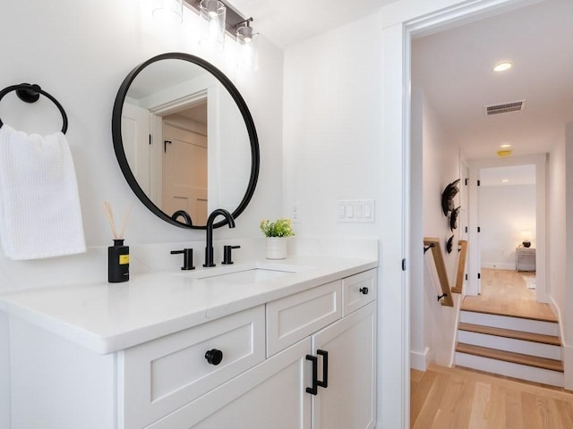 bathroom with vanity and wood-type flooring