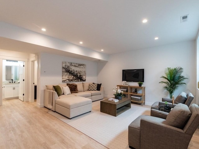 living room with sink and light wood-type flooring