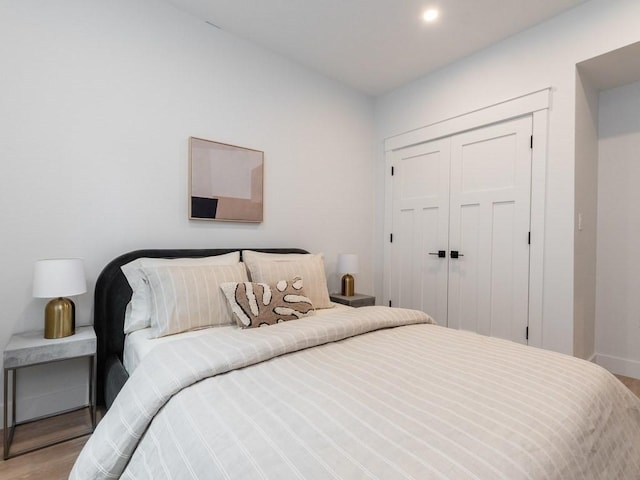 bedroom with a closet and light wood-type flooring