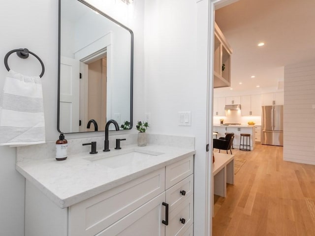 bathroom with hardwood / wood-style floors and vanity