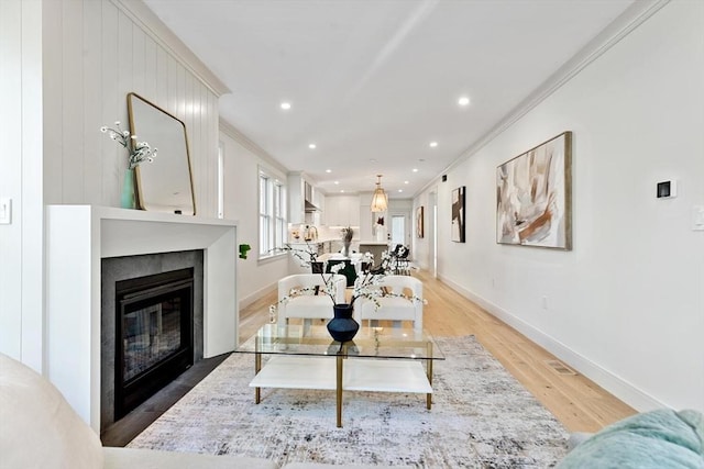 8 Holly Ave Unit 1, Cambridge, MA 02138 - living area featuring light wood-style floors, ornamental molding, baseboards, recessed lighting, and a glass covered fireplace