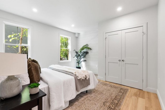 8 Holly Ave Unit 1, Cambridge, MA 02138 - bedroom featuring multiple windows, light wood finished floors, recessed lighting, a closet, and baseboards