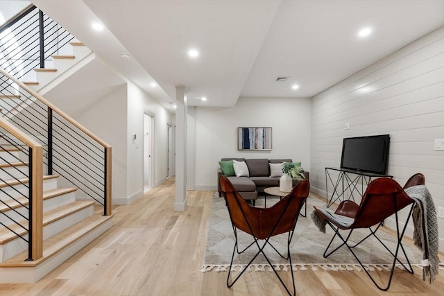 8 Holly Ave Unit 1, Cambridge, MA 02138 - living room featuring light wood-type flooring, stairs, baseboards, recessed lighting, and wooden walls