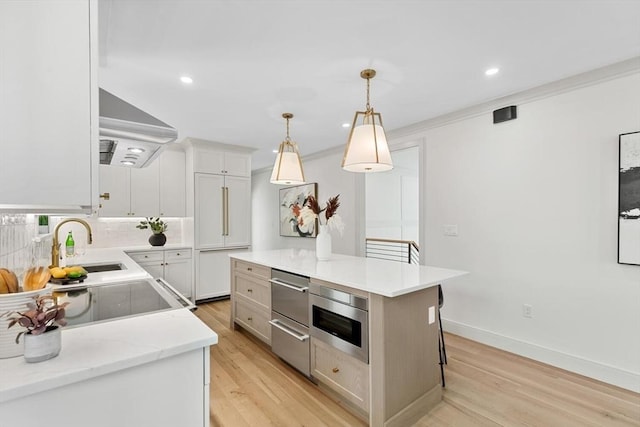 8 Holly Ave Unit 1, Cambridge, MA 02138 - kitchen with wall chimney range hood, light wood finished floors, a sink, tasteful backsplash, and recessed lighting