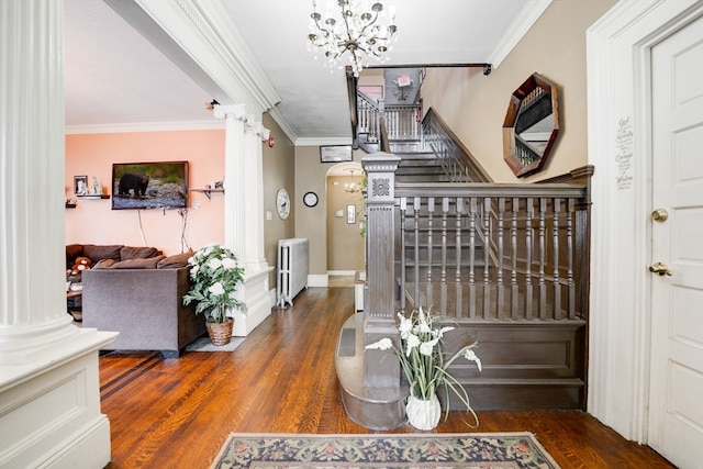 foyer with decorative columns, dark wood-type flooring, and crown molding